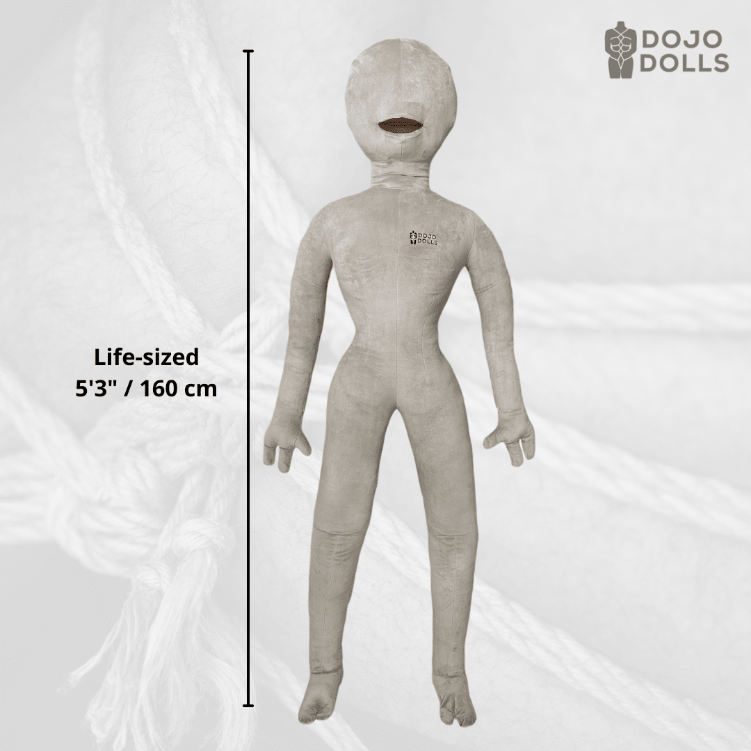 Regina 2.0 life-sized female shibari practice doll, 5'3" / 160 cm, shown standing against a background of jute rope.
