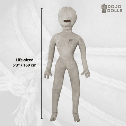 Regina 2.0 life-sized female shibari practice doll, 5'3" / 160 cm, shown standing against a background of jute rope.